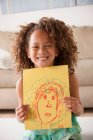 Girl holding a drawing — Stock Photo
