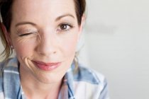 Portrait of brown eye mature woman looking at camera winking — Stock Photo