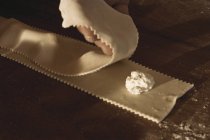 Cook making ravioli in kitchen, close-up partial view — Stock Photo