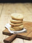 Stack of lemon cookies on tea towel — Stock Photo