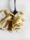Close up of lettuccine pasta on fork — Stock Photo