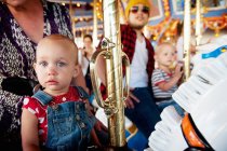 Family with two children on carousel — Stock Photo