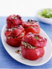 Plate of stuffed roasted peppers on table — Stock Photo