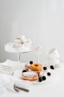 Plates of donuts with fruit — Stock Photo