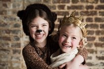 Young girls dressed up as cat and queen — Stock Photo