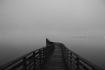 View of winding wooden pier over misty Puget Sound — Stock Photo
