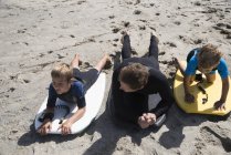 Man and two sons practicing on bodyboards, Laguna Beach, California, USA — Stock Photo