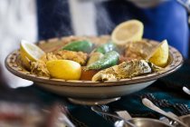 Tunisian restaurant dish of grouper with vegetables — Stock Photo