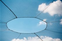 Net with hole inside, sky background — Stock Photo
