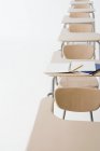 Empty classroom desks in a row — Stock Photo