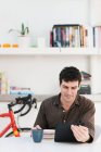 Mid adult man using digital tablet at home — Stock Photo