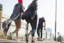 Skateboarders walking and skateboarding together on street, Budapest, Hungary — Stock Photo