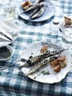 Portion of grilled fish with potatoes on plate — Stock Photo