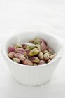 Peeled pistachios in bowl — Stock Photo