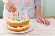 Imagen recortada de Mujer con pastel de cumpleaños - foto de stock
