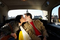 Couple kissing in London taxi — Stock Photo