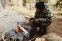 Männlicher Wanderer, der Kaffee am Lagerfeuer zubereitet, Mineralkönig, Mammutbaum-Nationalpark, Kalifornien, USA — Stockfoto