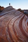 Hiker on the Fire Wave sandstone in the White Domes region of Valley of Fire State Park, Nevada. — Stock Photo