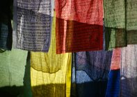Multi colored Prayer flags with orthographic text — Stock Photo