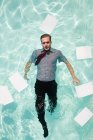 Office worker in swimming pool — Stock Photo