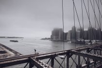 Foggy cityscape viewed from bridge — Stock Photo