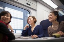 Young women talking on train — Stock Photo