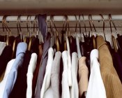 Clothes hanging in cupboard — Stock Photo