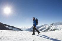 Man hiking in snow covered mountain landscape, Jungfrauchjoch, Grindelwald, Switzerland — Stock Photo