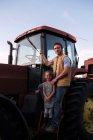 Portrait de père et fille à côté du tracteur — Photo de stock