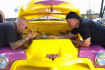 Mechanics working on colorful car — Stock Photo