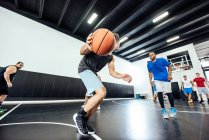 Jogador de basquete masculino correndo com bola na quadra de basquete — Fotografia de Stock