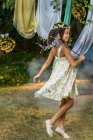 Young girl dressed as fairy, holding wand, playing outdoors — Stock Photo