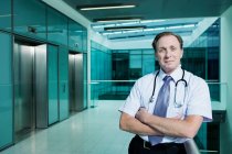 Portrait of doctor with arms folded — Stock Photo
