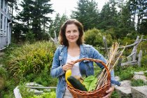 Mujer con verduras de jardín ecológico - foto de stock