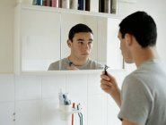 Teenage boy preparing to shave — Stock Photo