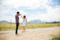 Young couple dancing in remote setting — Stock Photo