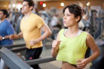 People using treadmills in gym — Stock Photo