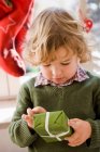 Young boy opening christmas present — Stock Photo