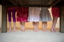 Girls standing together with barefeet in a row, low section — Stock Photo