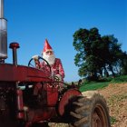 Gnome on a tractor — Stock Photo