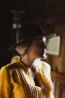 Portrait of woman in cabin, wearing cowboy hat — Stock Photo