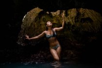 Woman in water filled cave and looking up, Oahu, Hawaii, USA — Stock Photo