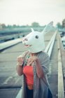 Young woman in rabbit costume mask in city — Stock Photo