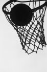 Silhouette of basketball hoop and ball against sky, close-up view — Stock Photo