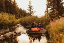 Family sitting on rock beside creek, fishing, Mineral King, Sequoia National Park, Californie (États-Unis) — Photo de stock