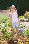 Girl holding watering can — Stock Photo