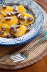 Dessert with orange and dried fruit with sugar powder — Stock Photo