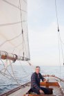 Man steering a sailing boat — Stock Photo
