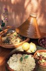 Lamb stew in tagine on served table — Stock Photo