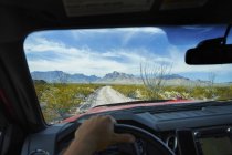Cropped image of man driving country dirty road in Big Bend National Park, Texas — Stock Photo